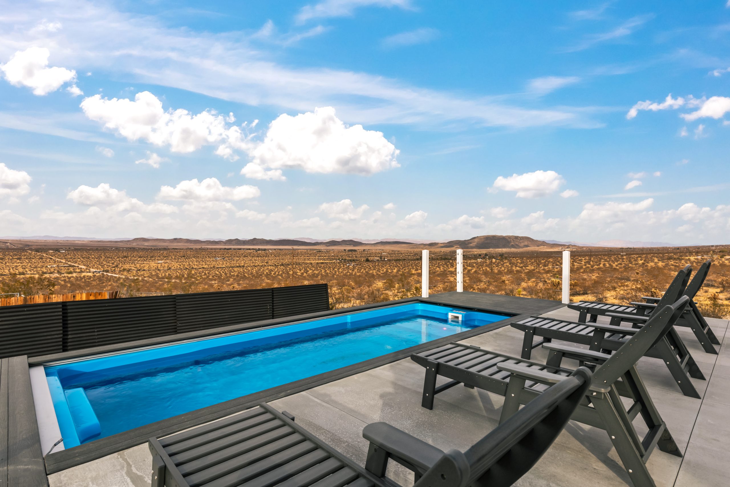 ContainUR container pool with blue pearl interior and wide desert views