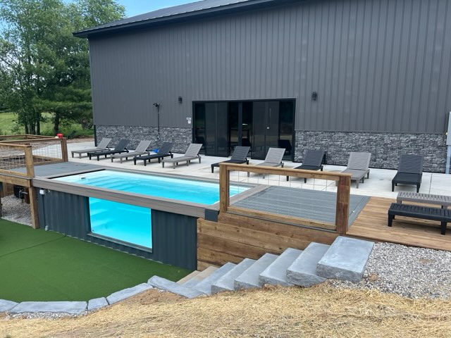 ContainUR container pool with glass viewing window and wood decking