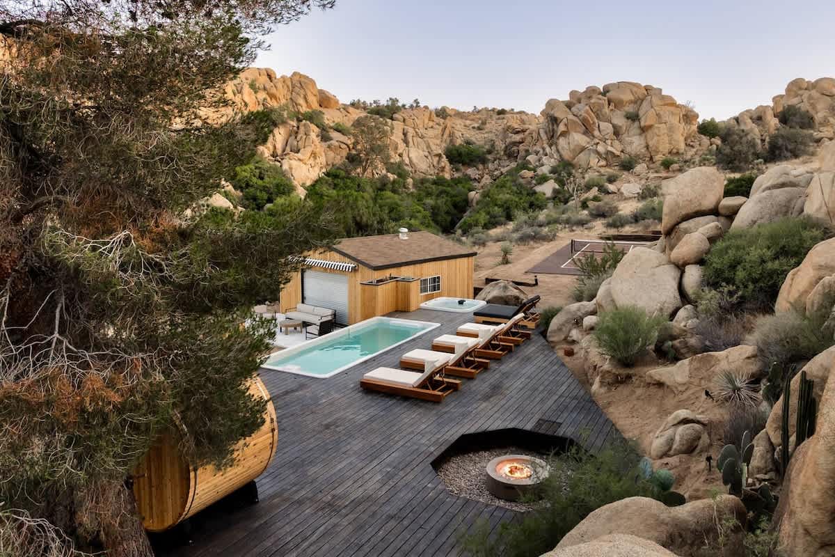 Container pool built into a desert hillside with deck at coping height, Joshua Tree, California