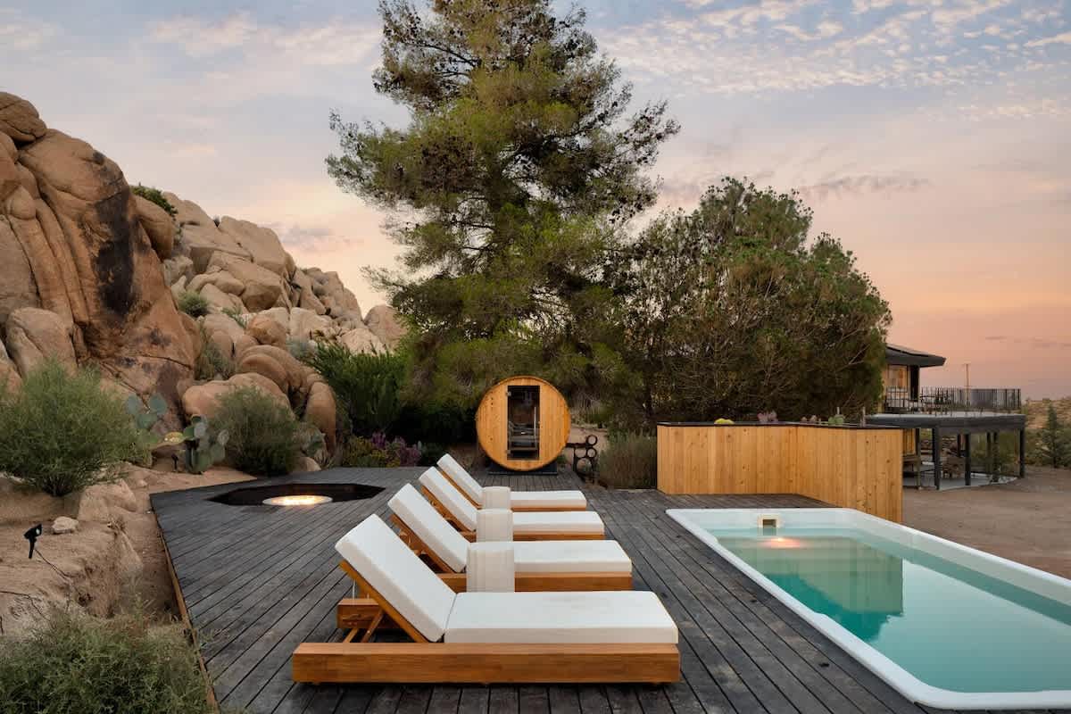 Container pool at sunset with loungers and fire pit, Joshua Tree, California