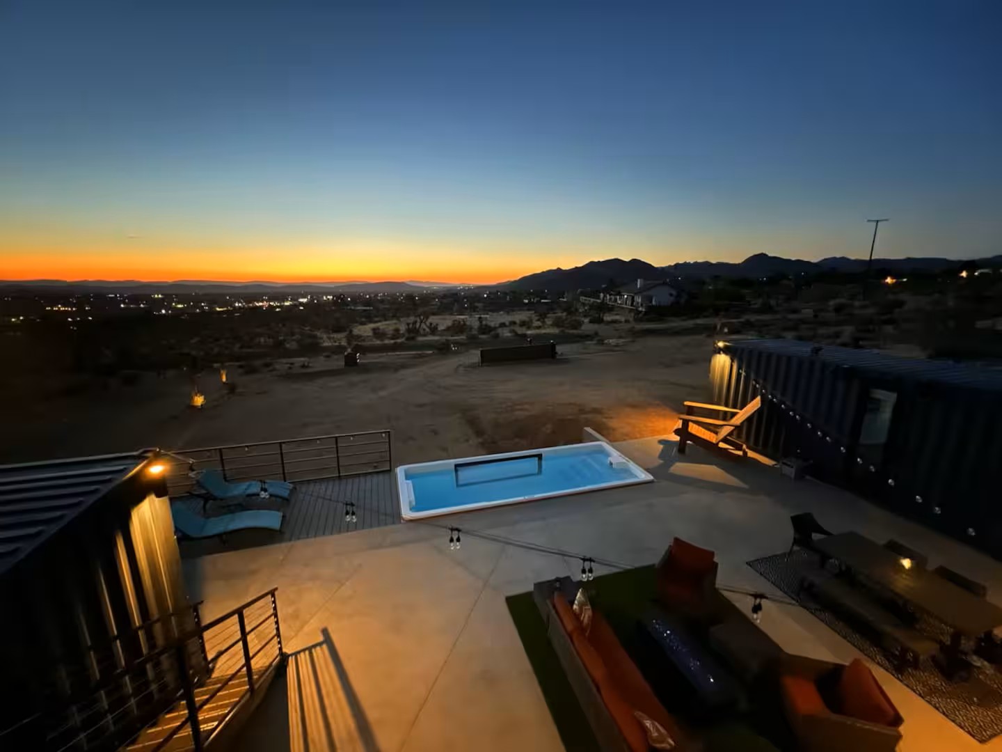 Container pool with viewing window at sunset overlooking the desert valley in Joshua Tree, California