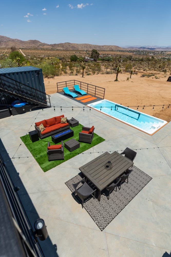 Container pool deck with lounge chairs overlooking desert and mountains in Joshua Tree, California