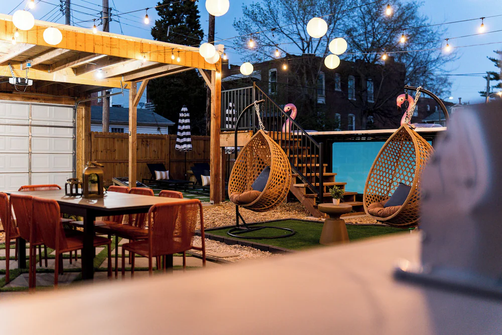 Pergola beams and string lights above a St. Louis backyard container pool