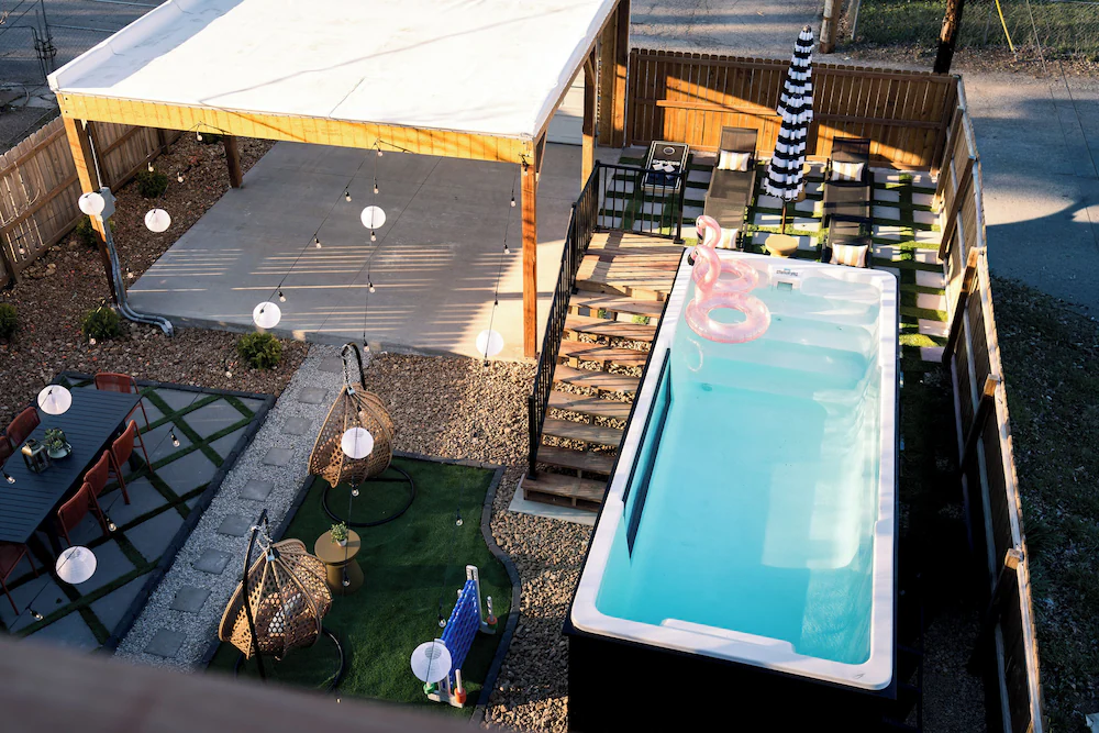 Aerial view of a container pool with white fiberglass interior, deck and turf in a St. Louis backyard