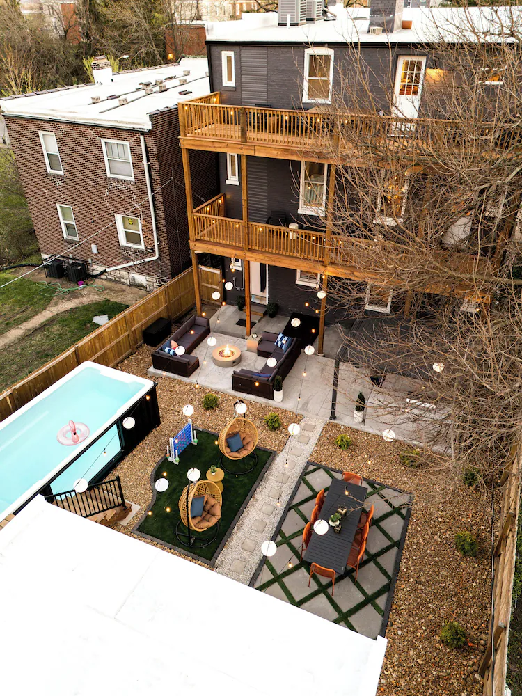 Aerial view of a container pool fitted along the fence line of a narrow St. Louis city backyard between two homes